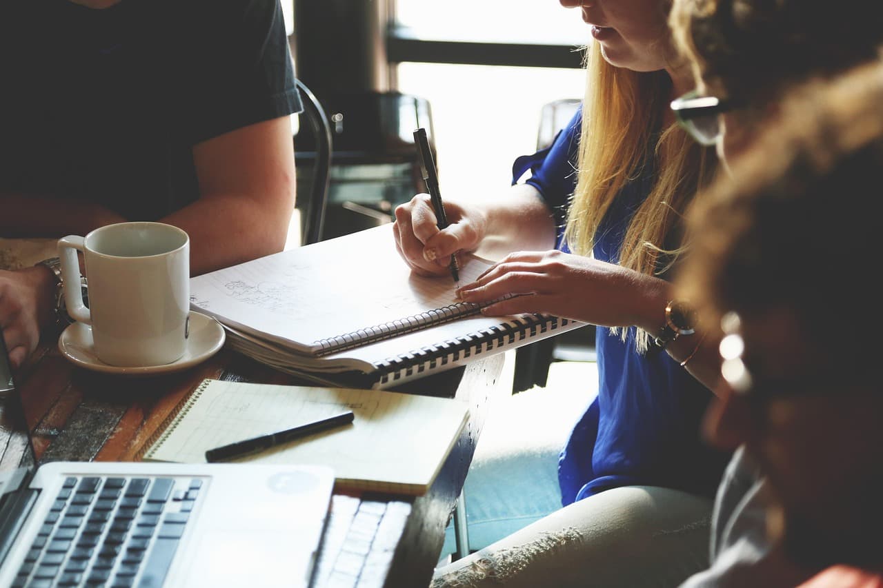 Freelancer workspace with laptop and notebook for business planning